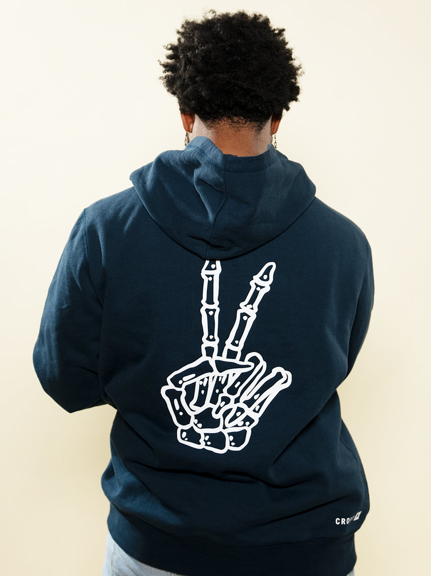 Full back side view of the navy Peace In Death hoodie with large skeletal peace sign. This hoodie is made from high quality organic cotton to give it a soft and comfortable feel