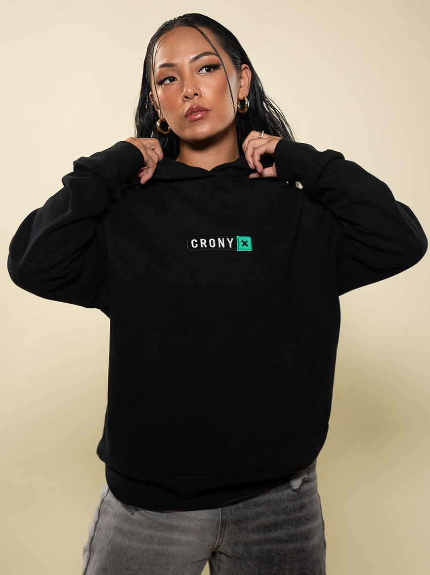 Female model wearing black CRONY X branded hoodie. These are made of premium, organic cotton giving it a soft, comfortable feel