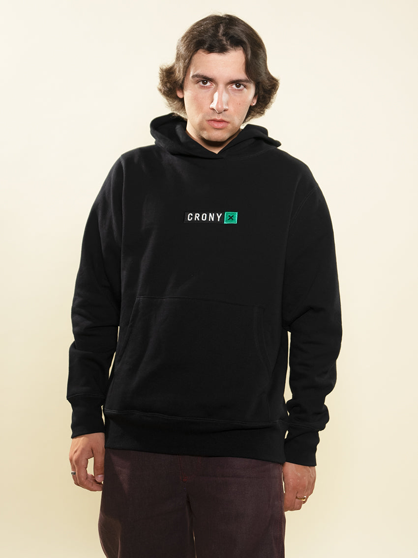 Male model wearing black CRONY X branded hoodie. These are made of premium, organic cotton giving it a soft, comfortable feel